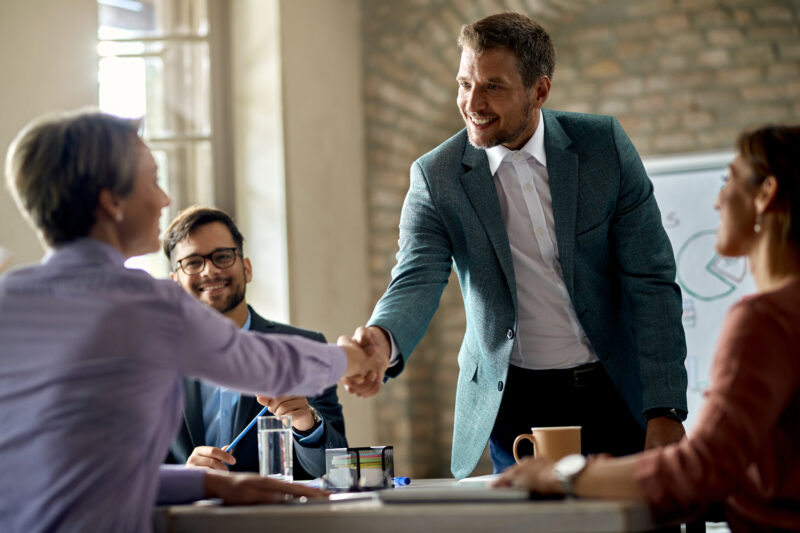 Business coworkers shaking hands during a meeting in the office.